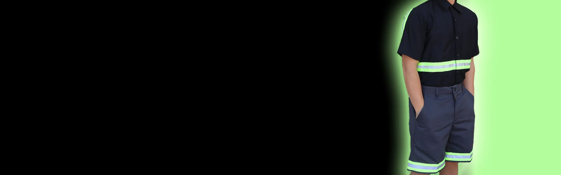 Worker illuminated in enhanced visibility workwear demonstrating bright reflective safety clothing